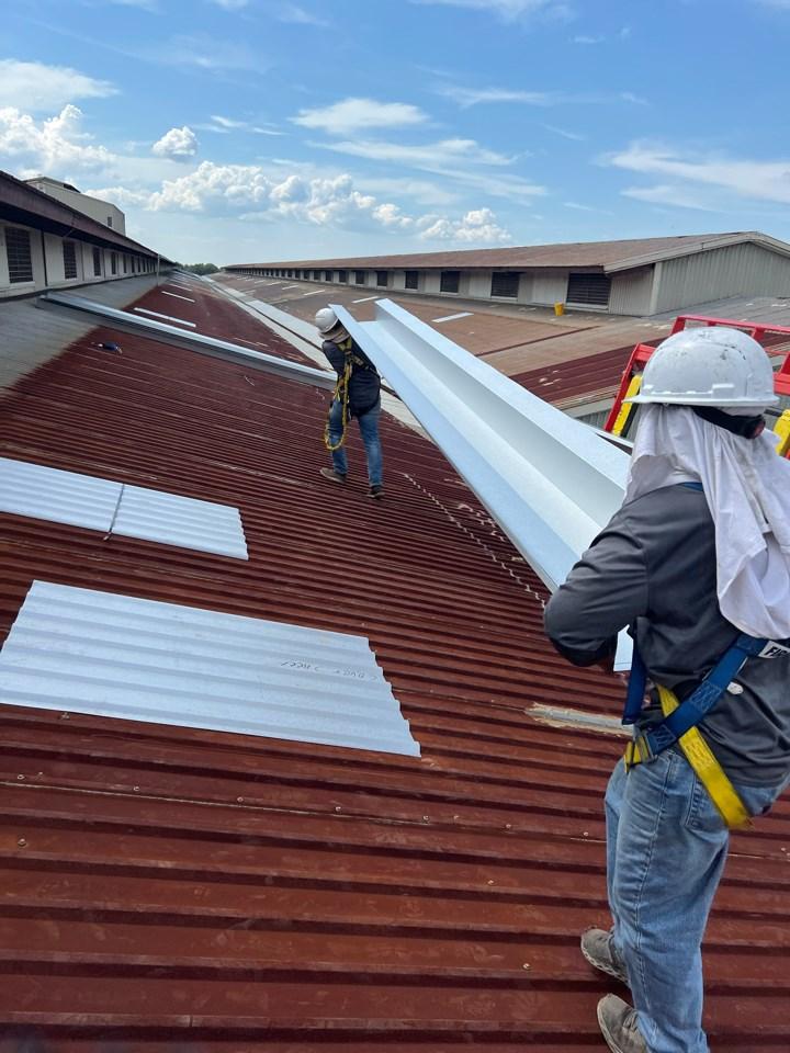 Two Metalguard Workers on a metal roof. This roof is prepared for hurricane season. 