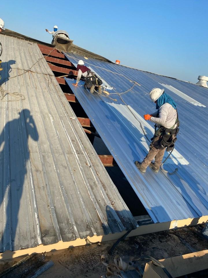 Metalguard workers installing new metal roofing panels