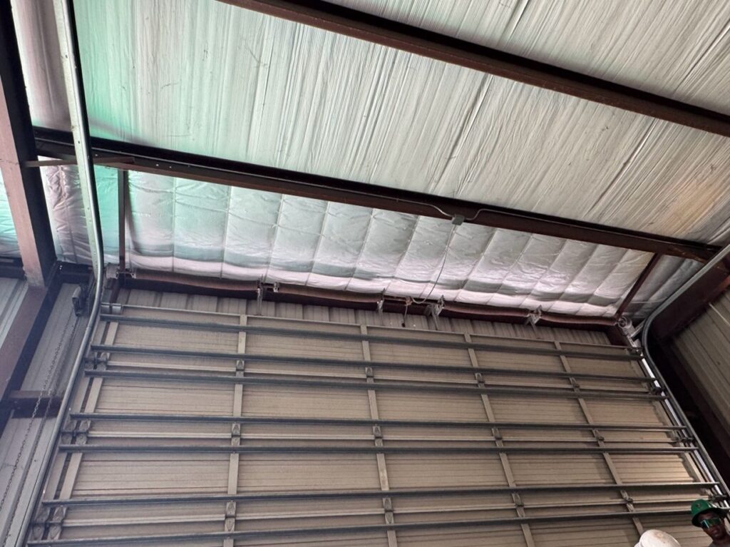 Metalguard Insulation Repair, Overhead door between purlins